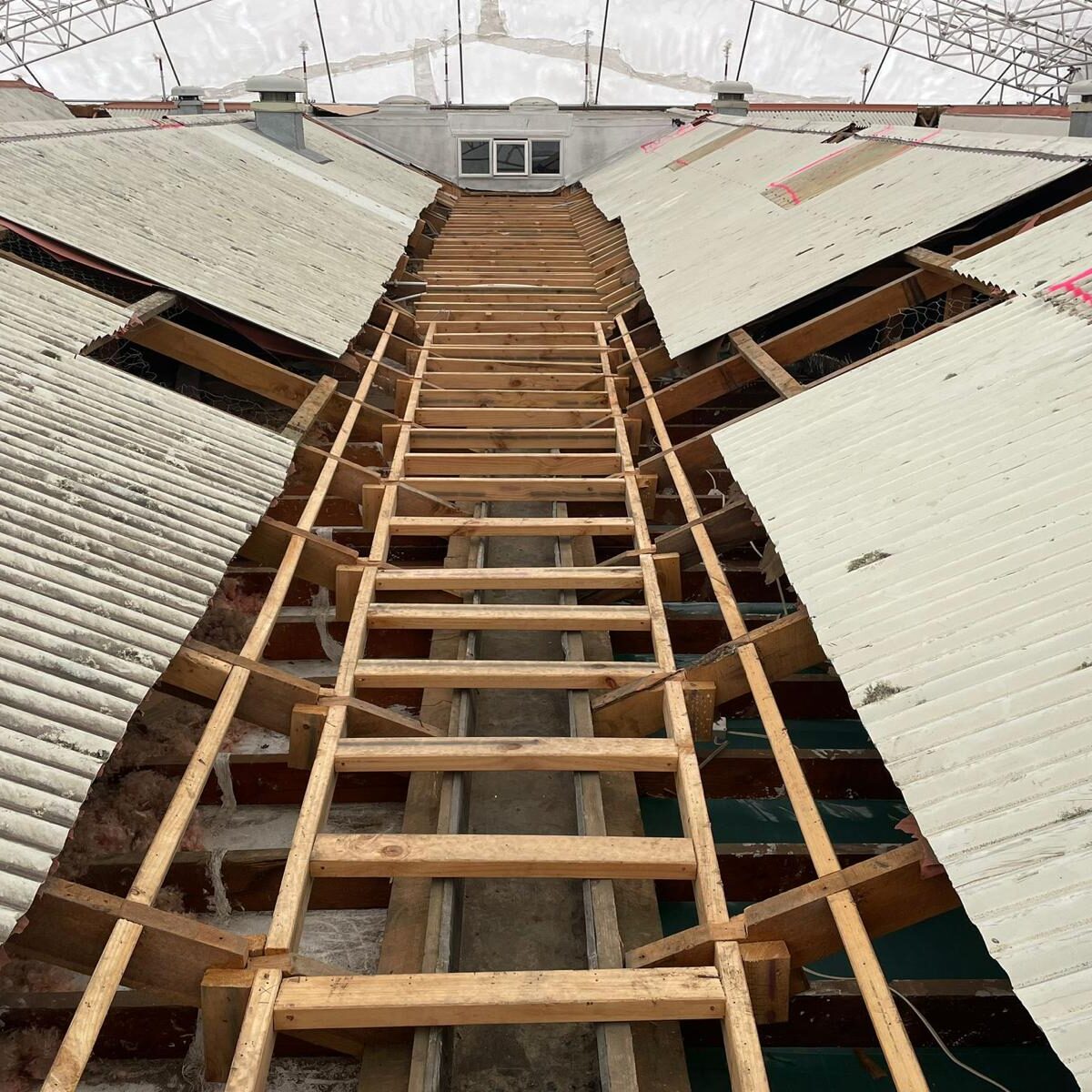 After photo - Asbestos Clearance received. Safe for roofing contractors to install new roof .