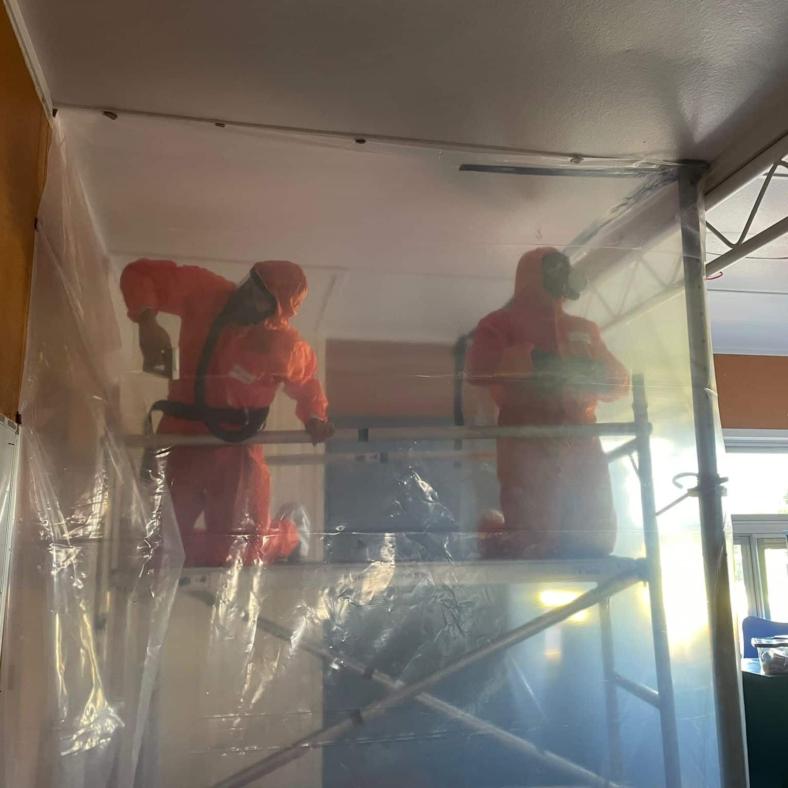 Technicians in full safety gear working on an asbestos removal job in Kaitaia